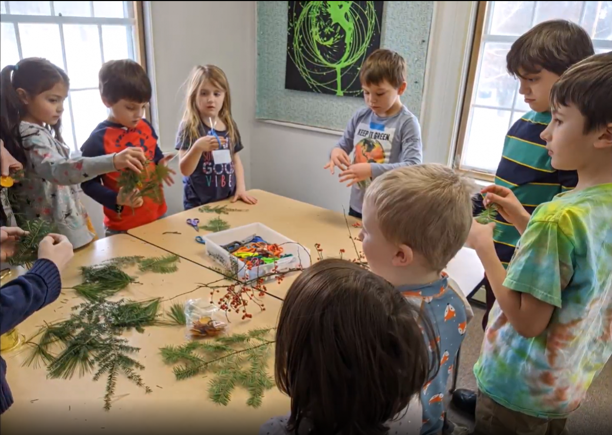 kids make decorations around a table