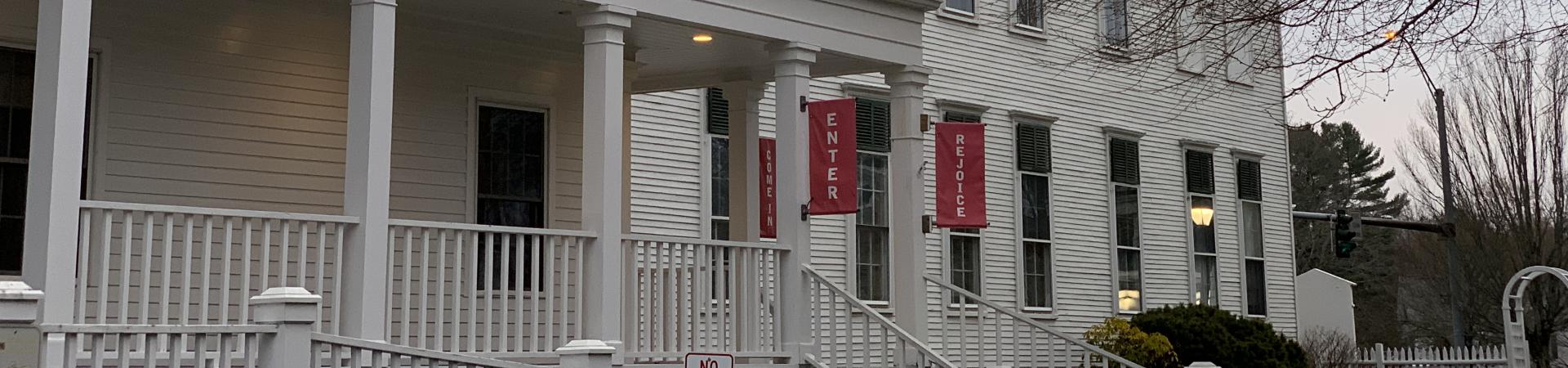 the outside of the church, hanging banners that say "enter, rejoice, and come in"